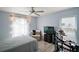 Bright bedroom featuring large window, black TV on dresser, and drumset at 38 Townhill Dr, Eustis, FL 32726