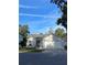 Well-kept gray brick home featuring a two-car garage and neat front lawn at 38 Townhill Dr, Eustis, FL 32726