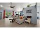 Bright living area with a tile floor, large sectional sofa and screened porch access at 38 Townhill Dr, Eustis, FL 32726