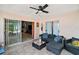Relaxing covered patio with comfortable seating and a ceiling fan at 38 Townhill Dr, Eustis, FL 32726