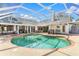 Aerial view of a large screened-in pool and patio area, ideal for outdoor enjoyment at 39206 Treeline Dr, Lady Lake, FL 32159