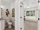 Half bathroom adjacent to an office space featuring coastal decor at 39206 Treeline Dr, Lady Lake, FL 32159