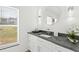 Bathroom with dark gray granite countertop and modern lighting at 39206 Treeline Dr, Lady Lake, FL 32159