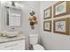 Tastefully decorated half-bathroom featuring coastal wall decorations and artwork at 39206 Treeline Dr, Lady Lake, FL 32159
