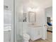 Bright bathroom with glass shower, granite counter, and door to bedroom at 39206 Treeline Dr, Lady Lake, FL 32159