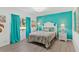 Bedroom with teal accent wall, bright window, and tropical patterned bed at 39206 Treeline Dr, Lady Lake, FL 32159