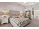 Spacious bedroom featuring a large upholstered headboard and ensuite bathroom at 39206 Treeline Dr, Lady Lake, FL 32159