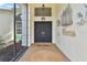 Inviting front entrance featuring double doors, stylish decor, and a warm welcome mat at 39206 Treeline Dr, Lady Lake, FL 32159
