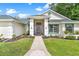 Welcoming home featuring a covered porch with an elegant entrance at 39206 Treeline Dr, Lady Lake, FL 32159