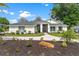 Charming single story home with a landscaped front yard, lush lawn, and a paved walkway at 39206 Treeline Dr, Lady Lake, FL 32159