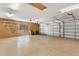 Spacious garage with ample storage, shelving, and multiple garage doors at 39206 Treeline Dr, Lady Lake, FL 32159