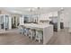 Modern kitchen with island seating, stainless appliances, and an open layout to the living area at 39206 Treeline Dr, Lady Lake, FL 32159