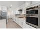 Modern kitchen with stainless steel appliances, sleek white cabinets, and stylish backsplash at 39206 Treeline Dr, Lady Lake, FL 32159