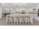 Modern kitchen with a large island, stylish stools, and ample counter space for cooking at 39206 Treeline Dr, Lady Lake, FL 32159