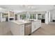 Spacious kitchen with a large island, stainless steel dishwasher, and an open layout to the living spaces at 39206 Treeline Dr, Lady Lake, FL 32159