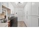 Bright laundry room features white cabinetry, modern washer/dryer, and stylish decor at 39206 Treeline Dr, Lady Lake, FL 32159