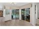 Bright living room with sliding glass doors to lanai and dining area with backyard pool view at 39206 Treeline Dr, Lady Lake, FL 32159