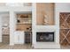 Cozy fireplace features built-in shelving, a wet bar, and stylish design elements at 39206 Treeline Dr, Lady Lake, FL 32159