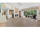 Open floor plan boasts a fireplace, wet bar, and seamless access to a screened lanai with pool at 39206 Treeline Dr, Lady Lake, FL 32159