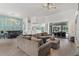 Spacious living room boasts modern decor, a large sectional, and views of the backyard pool at 39206 Treeline Dr, Lady Lake, FL 32159