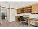 Spacious office area with built-in wooden cabinets, a desk, and natural light at 39206 Treeline Dr, Lady Lake, FL 32159