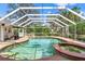 Serene pool and spa area with a screened enclosure and picturesque views of the surrounding landscape at 39206 Treeline Dr, Lady Lake, FL 32159