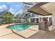 Inviting pool and spa with screened enclosure, complemented by an outdoor bar and seating at 39206 Treeline Dr, Lady Lake, FL 32159