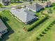 An aerial view shows the property's neatly landscaped yard and manicured hedges, offering privacy and curb appeal at 39653 Grove Hts, Lady Lake, FL 32159