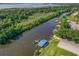 Aerial view of waterfront homes featuring private boat docks, lush landscaping, and easy access to the river and lake at 39653 Grove Hts, Lady Lake, FL 32159