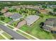 Overhead view of a home with neatly manicured landscaping, a paver driveway, and a lush green lawn at 39653 Grove Hts, Lady Lake, FL 32159