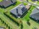 An aerial view displays a property featuring solar panels, a landscaped yard, and outdoor furniture on the patio at 39653 Grove Hts, Lady Lake, FL 32159