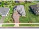 Wonderful aerial view of a single-story home with extensive landscaping, and a long paver driveway at 39653 Grove Hts, Lady Lake, FL 32159