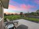Outdoor patio featuring comfortable lounge chairs and landscaping, perfect for relaxing and enjoying the scenic backyard view at 39653 Grove Hts, Lady Lake, FL 32159