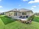 Serene backyard featuring a well-manicured lawn, a patio, and colorful flowerbeds at 39653 Grove Hts, Lady Lake, FL 32159