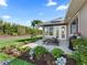 Beautiful backyard with patio, lounge chairs, manicured lawn, and lovely garden beds at 39653 Grove Hts, Lady Lake, FL 32159