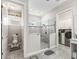 Tiled walk-in shower and adjacent toilet and laundry rooms at 39653 Grove Hts, Lady Lake, FL 32159