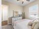 Cozy bedroom featuring a dresser with mirror, a ceiling fan and a window bringing in natural light at 39653 Grove Hts, Lady Lake, FL 32159