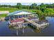 Aerial view of a private boat dock with multiple boat slips providing convenient waterfront access and recreational opportunities at 39653 Grove Hts, Lady Lake, FL 32159