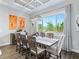 Bright dining area featuring a large window, elegant lighting, and seating for eight at 39653 Grove Hts, Lady Lake, FL 32159