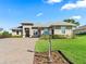 Charming single-story home with manicured lawn, flower beds, a paver driveway and a welcoming front entrance at 39653 Grove Hts, Lady Lake, FL 32159