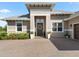 Close up exterior shot of a single-story home showing the front door, paver driveway, and manicured landscape at 39653 Grove Hts, Lady Lake, FL 32159