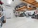 Organized garage featuring epoxy flooring, overhead racks, and tool storage at 39653 Grove Hts, Lady Lake, FL 32159