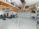 Spacious garage with epoxy flooring, overhead storage racks, and two car doors at 39653 Grove Hts, Lady Lake, FL 32159