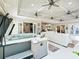 Full hot tub area featuring a hot tub, ceiling fans, and steps for easy access at 39653 Grove Hts, Lady Lake, FL 32159