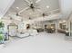 Expansive living area with multiple ceiling fans, large sectional sofa, fireplace, and open layout to dining at 39653 Grove Hts, Lady Lake, FL 32159