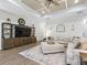 Spacious living room featuring a coffered ceiling, modern furnishings, and a large entertainment center at 39653 Grove Hts, Lady Lake, FL 32159