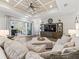Cozy living room with a coffered ceiling, plush sectional, and sliding glass doors to outdoor living space at 39653 Grove Hts, Lady Lake, FL 32159