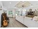 Spacious living room features decorative ceiling, recessed lighting, wood floors, and comfortable furnishings at 39653 Grove Hts, Lady Lake, FL 32159