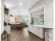 Bright, open layout with kitchen, dining area, and window offering views into the living room at 39653 Grove Hts, Lady Lake, FL 32159