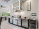 An outdoor kitchen with a stainless steel grill, beverage cooler, and decor at 39653 Grove Hts, Lady Lake, FL 32159